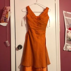 I am selling an DaVinci Bridesmaid dress, in a dark orange color, size 2